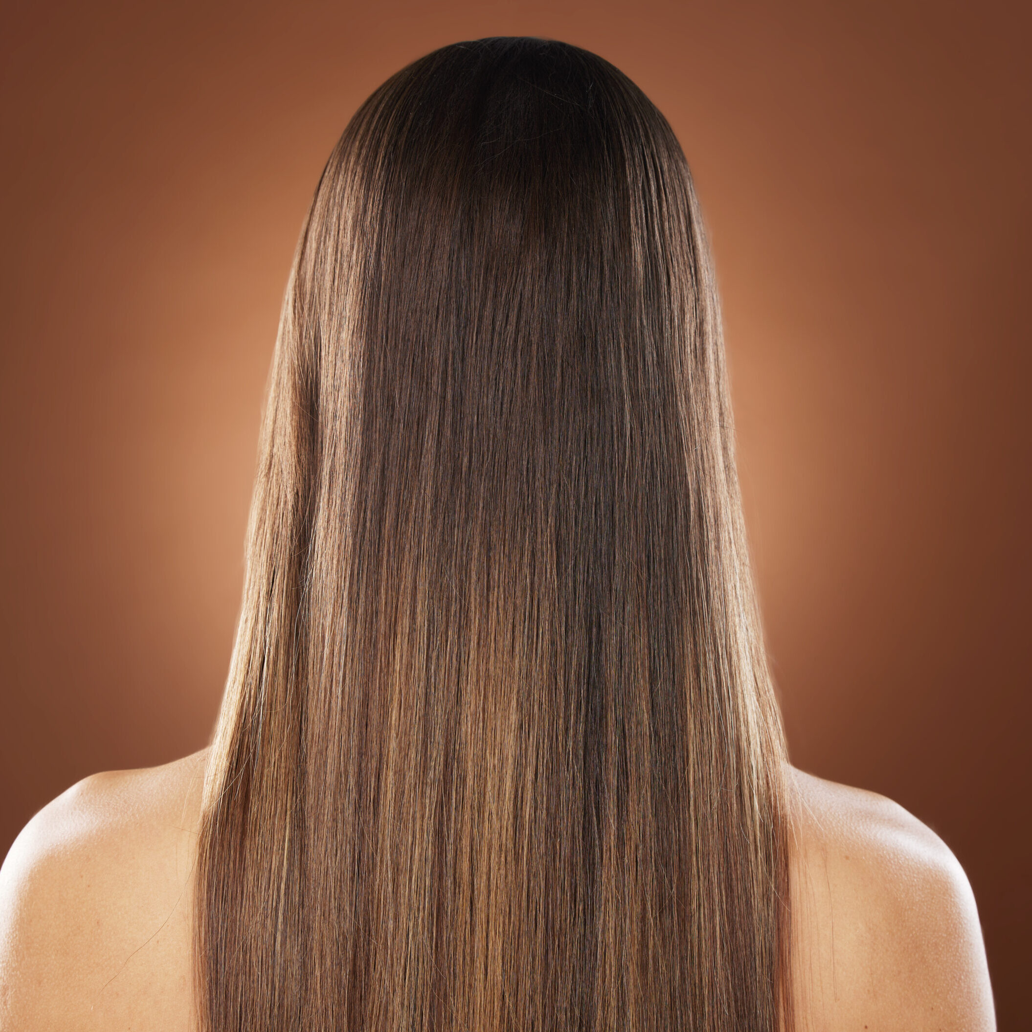 Woman, back or hair style on brown background in relax studio for keratin treatment, self care well.