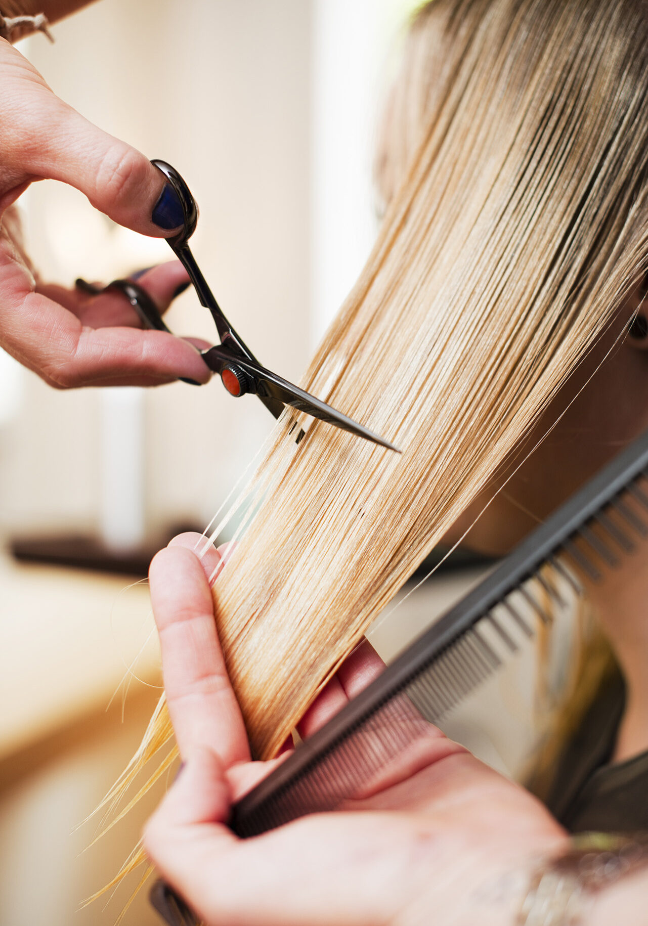 Woman having haircut in salon